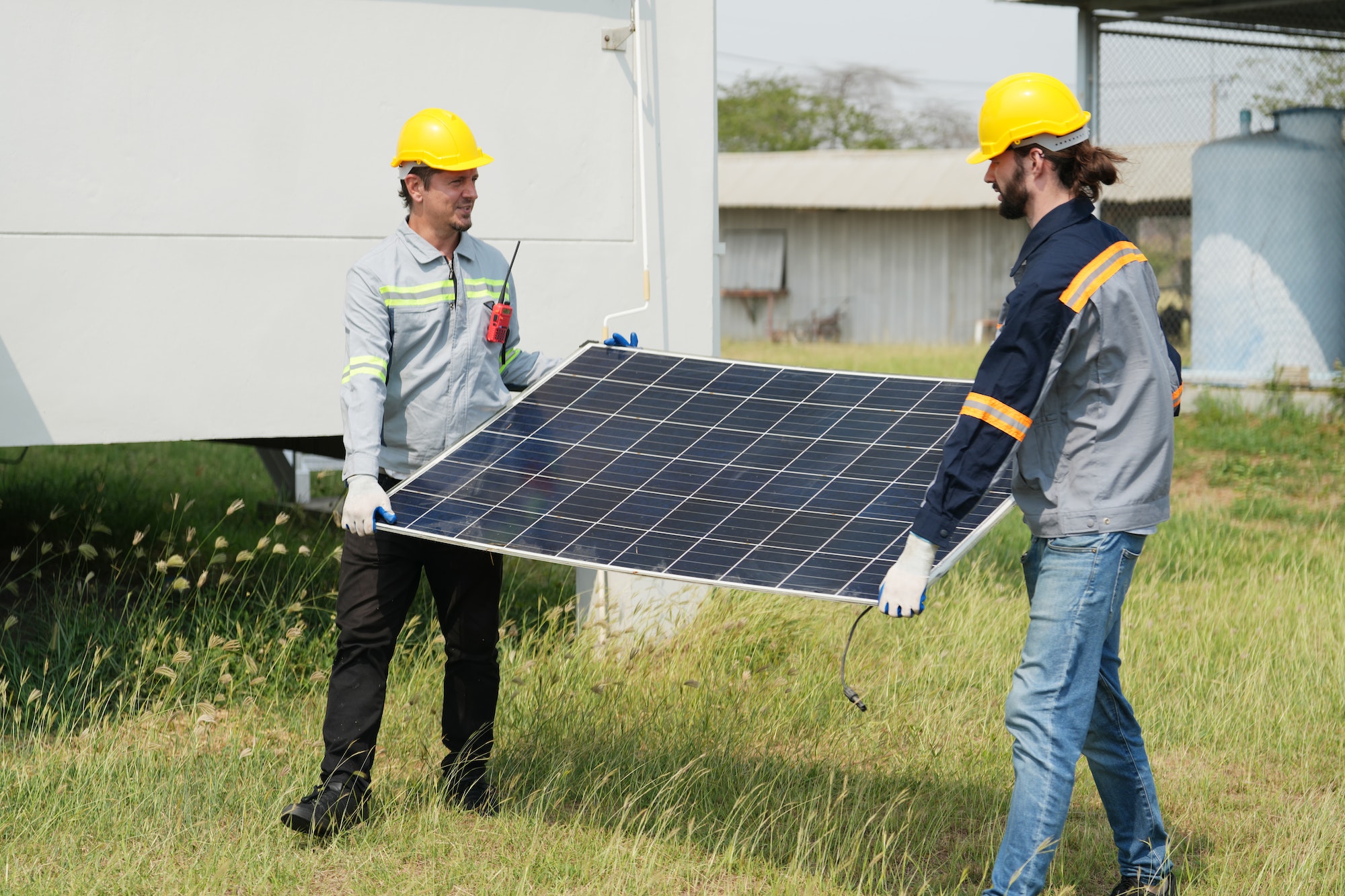 Solor voltaic panels, indusrty engineer working at construction of solar farm. energy industry.